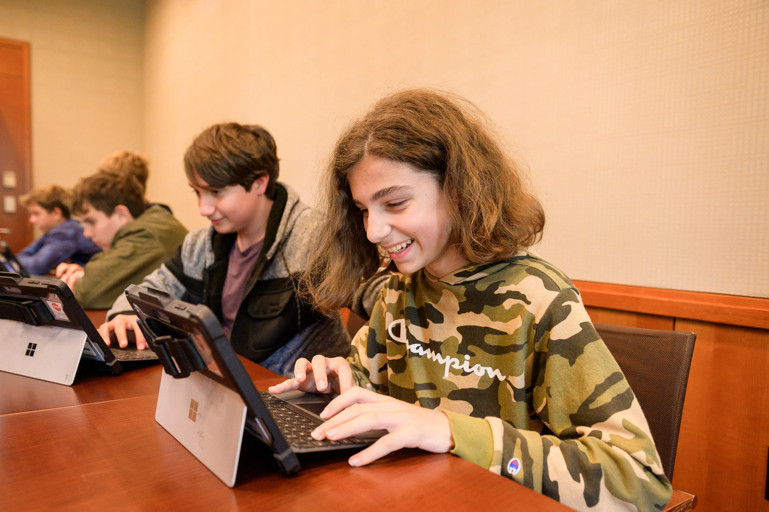 A child on an ipad, smiling