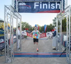 runner crossing finish line