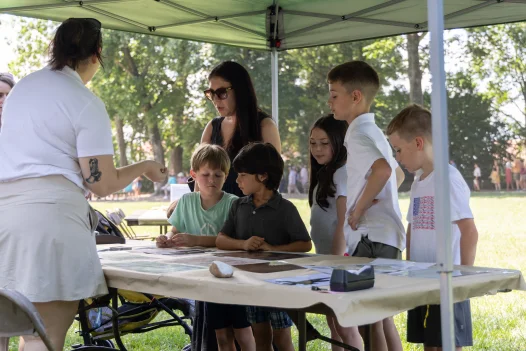Mount Vernon educators talking to a family of visitors