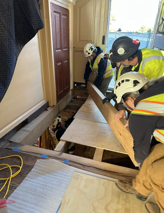 Carpenters install the last new timber