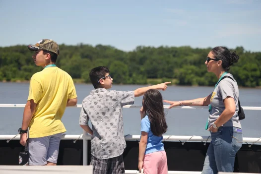 Family with kids on photo cruise boat