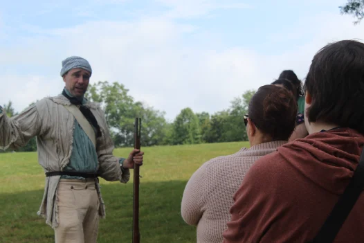 Interpreter in Revolutionary War Encampment with teachers