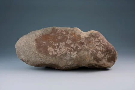 A flaked, pecked, and ground grubbing or digging tool. Such tools were used from the Middle Archaic through the Woodland periods. (MVLA)