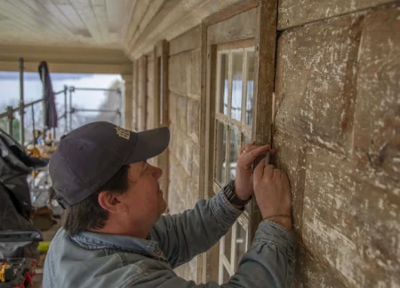 Preservation Carpenter Pete Seroskie applies butvar to secure a wood fill behind the south Lafayette Room window. Photo by Caroline Spurry.