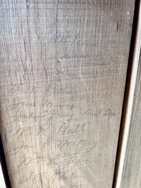 Inside of the piazza's third pillar (from the south), the Preservation team discovered the 10 penciled names of the craftsmen who had previously worked on the pillars. (MVLA)