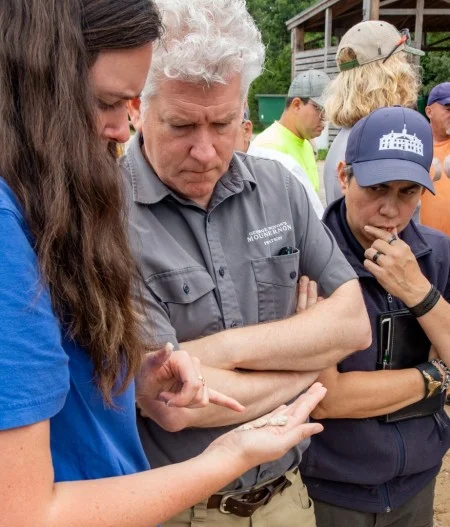 Preservation Conservator Riley Morris, Director of Preservation Tom Reinhart, and Restoration Manager Amy McAuley discuss mortar and quicklime fragments. (MVLA)