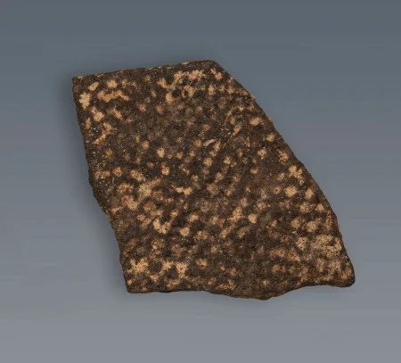 A fragment from the rim of a ceramic storage vessel that has been tempered with sand. (MVLA)