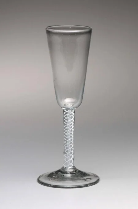 This example is similar to the "enameled" ale glasses Washington acquired from London in the 1760s and 1770s. The term "enameled" refers to the opaque white glass rods embedded in the stem, which glassmakers fashioned into a dazzling variety of spirals, gauzes, and twists. (MVLA)