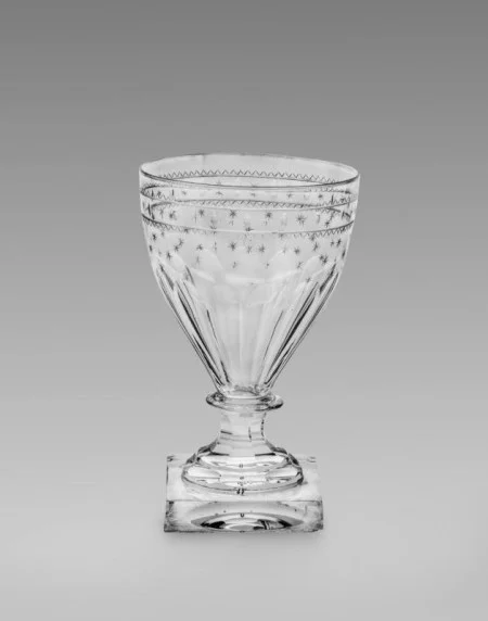 The heavy, stepped foot of this vessel and its engraved decoration suggest it was purchased by George Washington in the 1790s. The Washingtons likely used it to serve claret at Mount Vernon. Rummers derived their name from the German drinking glass known as a "roemer," which featured a large bowl. (MVLA)
