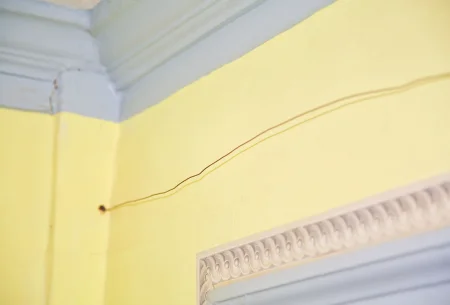 Bell-wire fed from the exterior into the Yellow Room, prior to the 2021 partial restoration. (MVLA)