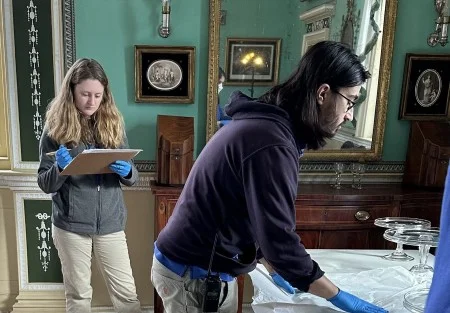Two members of Mount Vernon’s Fine and Decorative Arts Collections team begin the process of de-installing the New Room ahead of Mansion Revitalization work. (MVLA)