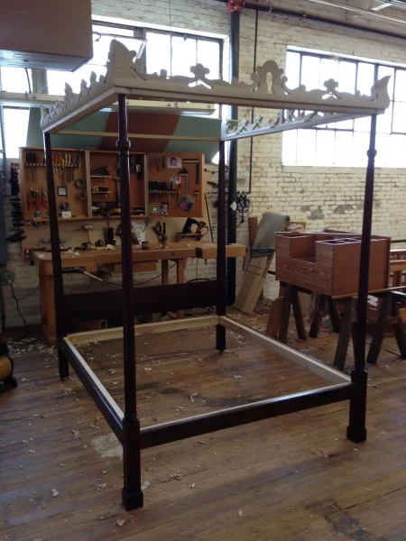 The reproduction dressing table, in progress, sits on the workbench to the side of the completed reproduction bedstead for the Blue Room. Courtesy of Harrison Higgins, Inc., Richmond, Virginia. (MVLA)