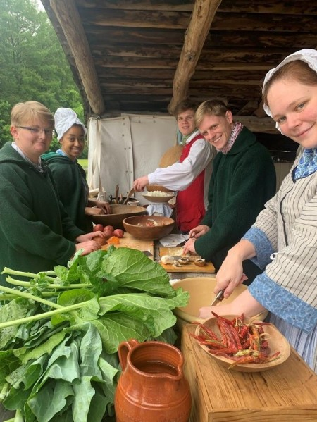 Interns and Historic Trades staff making pepper pot stew.