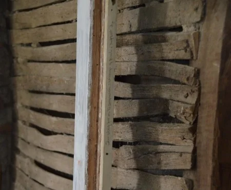In 2018, the Architecture team discovered a note from Dodge written in pencil along a narrow wood fill running the full height of a panel in the Front Parlor. (MVLA)