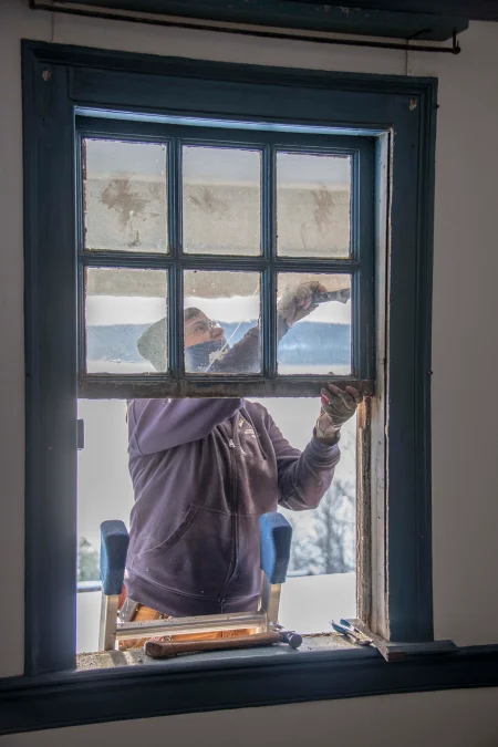 Preservation Joiner Amy McAuley removing the north Lafayette Room window for restoration.