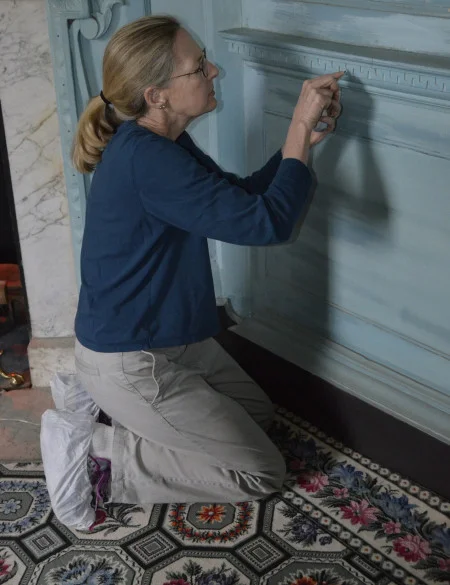 Dr. Susan Buck taking paint samples in the front parlor, MVLA.