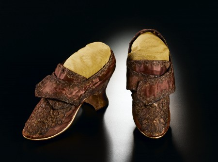 The combination of expensive, imported yellow and purple silks with silver and gold decorations would have produced a regal appearance that conveyed her elevated social and economic standing. [W-2667/A-B]