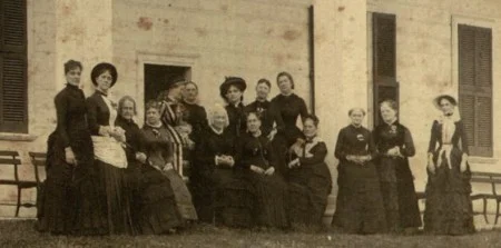 Around 1882-1883, the Regent and Vice Regents pose for a photograph on the piazza of the Mansion. Mrs. Ball, the Vice Regent for Virginia, is on the far left.