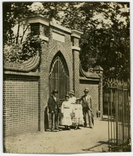 Two men, a woman, and two children standing in front of tomb.  © MVLA [DA_001717]