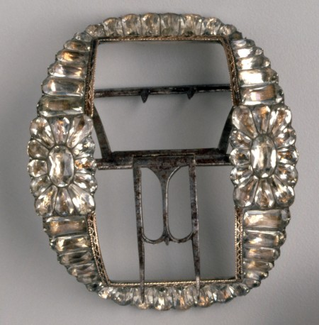 The large size of these silver and paste (cut and faceted glass) shoe buckles is typical of buckles worn by both men and women during the late eighteenth century. [M-4085/B] Gift of Mr. and Mrs. H. Michael Tyson of Houston, Texas, 2000