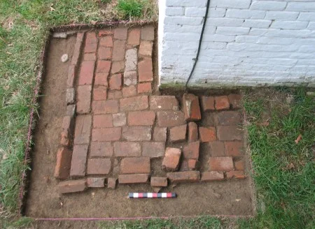 Just below topsoil is a two-foot-wide brick pad. This brick surface may have acted as a gutter to run rain water away from the buildings’ foundations. (MVLA)