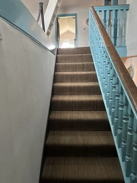This garret staircase, connecting the second-floor landing to the third floor, was a subject of conversation in letters between Washington and George William Fairfax. It became part of a circuitous route that would have made the labor-intensive maintenance of the household even more time-consuming for the enslaved workers. (MVLA)