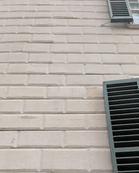 The Mansion with pounded sandstone thrown on the wet paint.