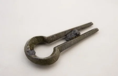 Used in many regions of the world, the jaw harp was a common instrument among the enslaved at Mount Vernon and other plantations. Musicians placed the rounded end of the harp at the front of their mouths and used a finger to pluck the central vibrating tongue (only a small portion of the tongue survives on this example). This artifact was found near the Dung Repository during a 2015 excavation at Mount Vernon. (MVLA)