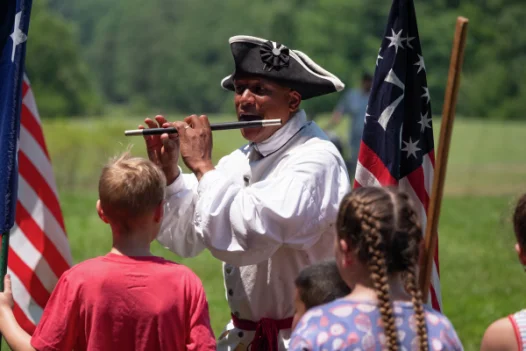 Don Francisco plays the fife during his program, Music of the Revolution.